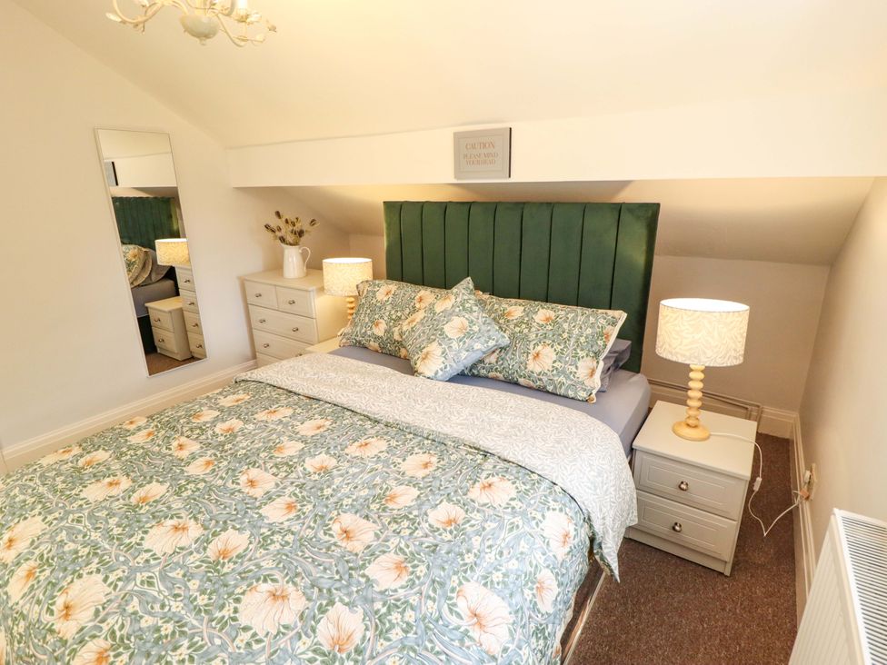 A bedroom with a bed and bedside lamp at Wood Farm Cottage Stickney near East Kirkby