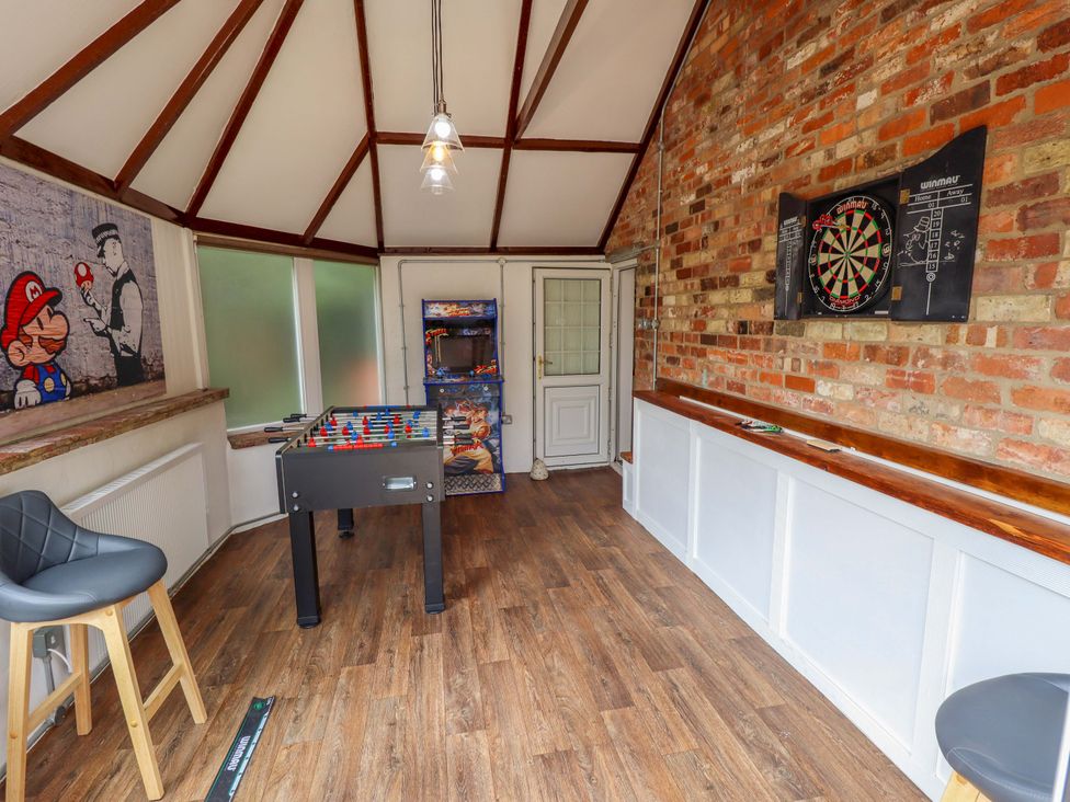 A games room with a foosball table and a dartboard at Wood Farm Cottage Stickney near East Kirkby