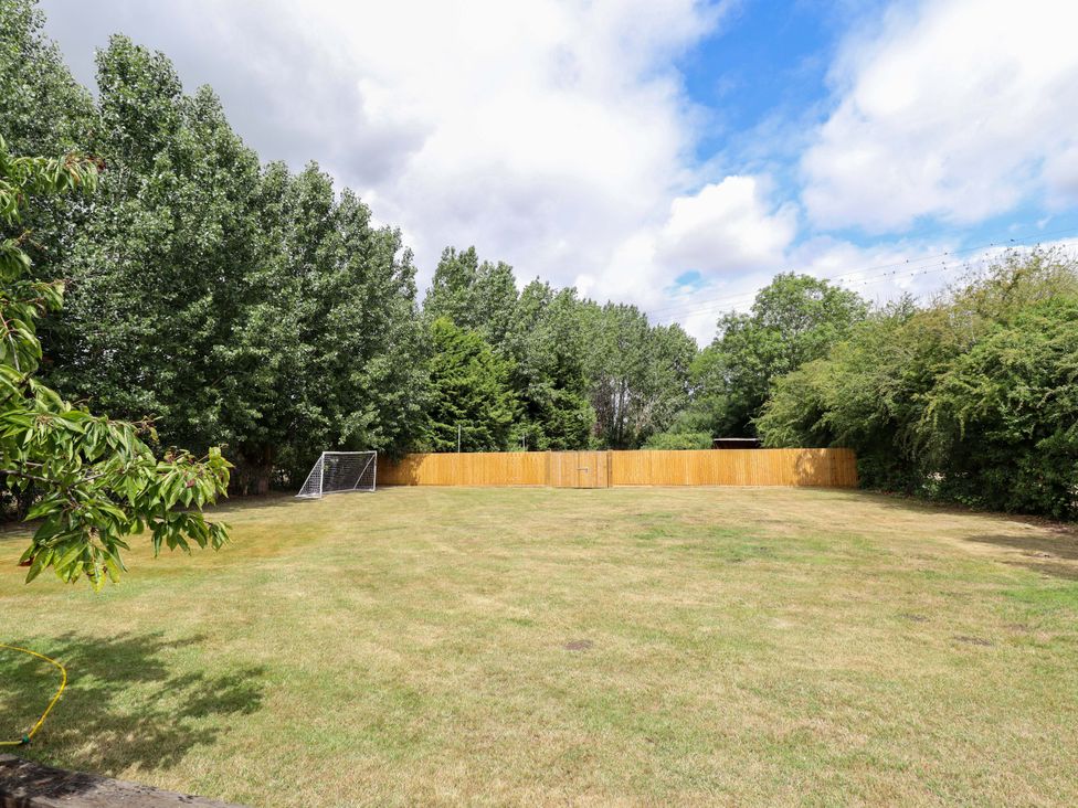A backyard with a goalpost and trees at Wood Farm Cottage Stickney near East Kirkby