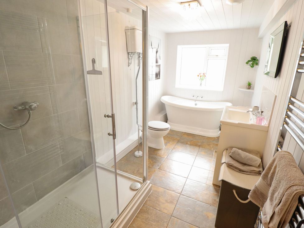 A bathroom with a shower, bathtub, toilet, and sink at Wood Farm Cottage Stickney near East Kirkby