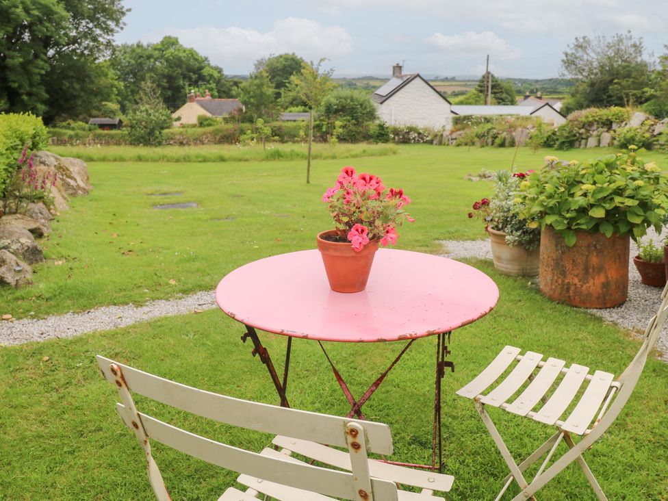 An outdoor area with a table and chairs at Teg in Prospidnick near Porthleven