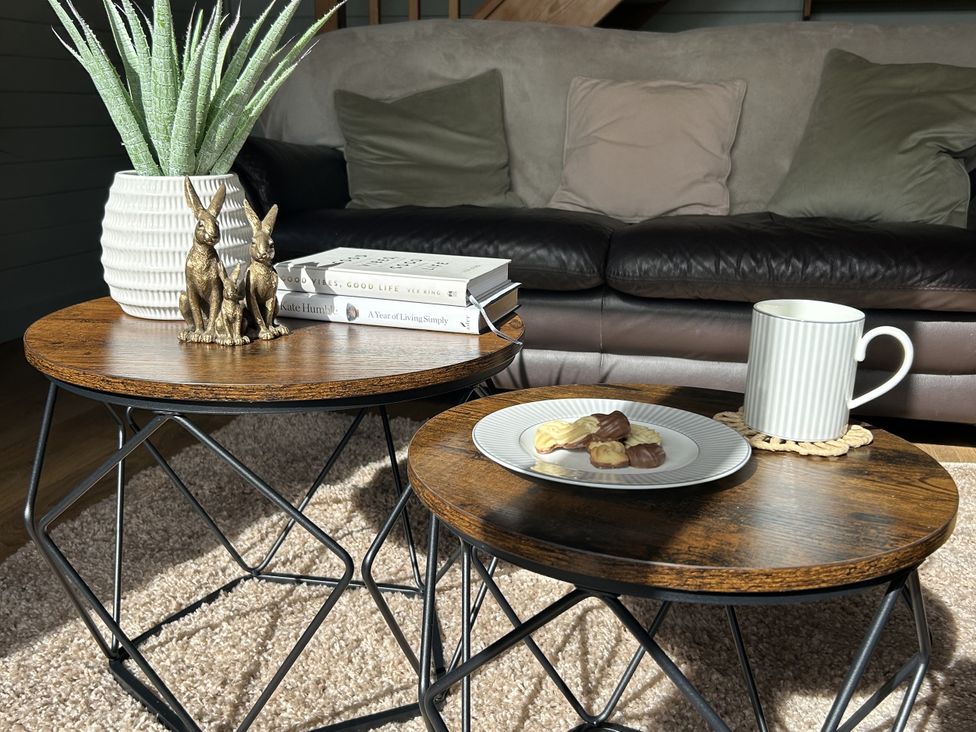 A living room with tables and a sofa at Number 39 in Bodmin