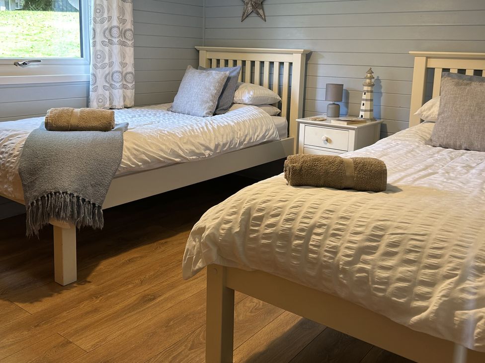A bedroom with twin beds and a nightstand at Number 39 Bodmin