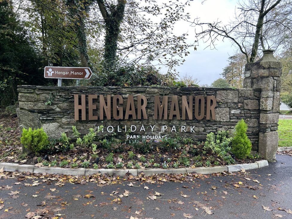 A sign for Hengar Manor Holiday Park with surrounding greenery at Hengar Manor in Bodmin