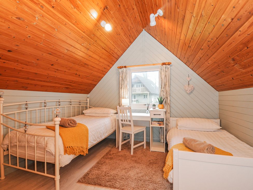 A bedroom with two beds and a desk at Cornish Woodland Retreat Near St Tudy