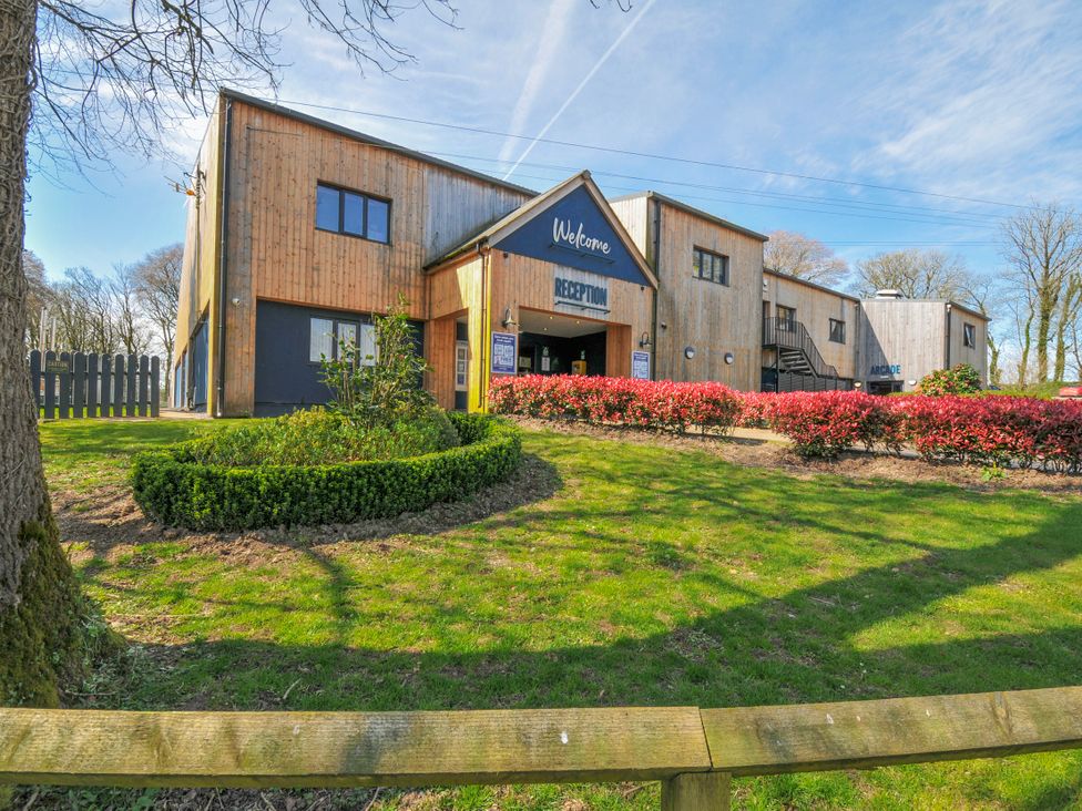 A building with reception area and signage at Cornish Woodland Retreat near St Tudy