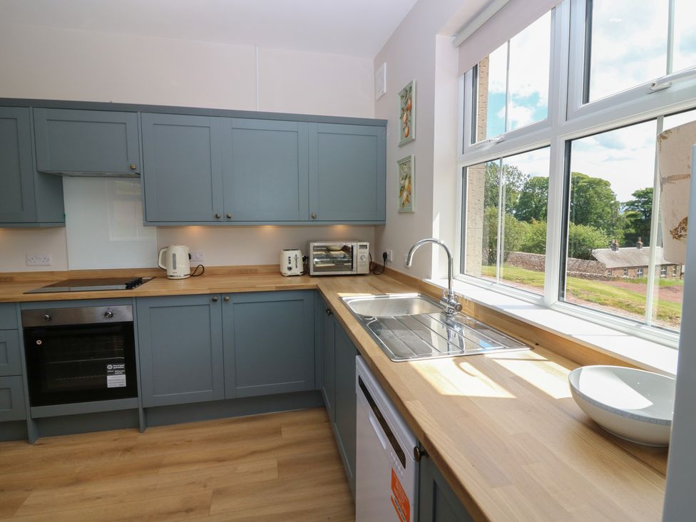 A kitchen with cabinets, sink, and appliances at No 6 - 2 bed Haddington