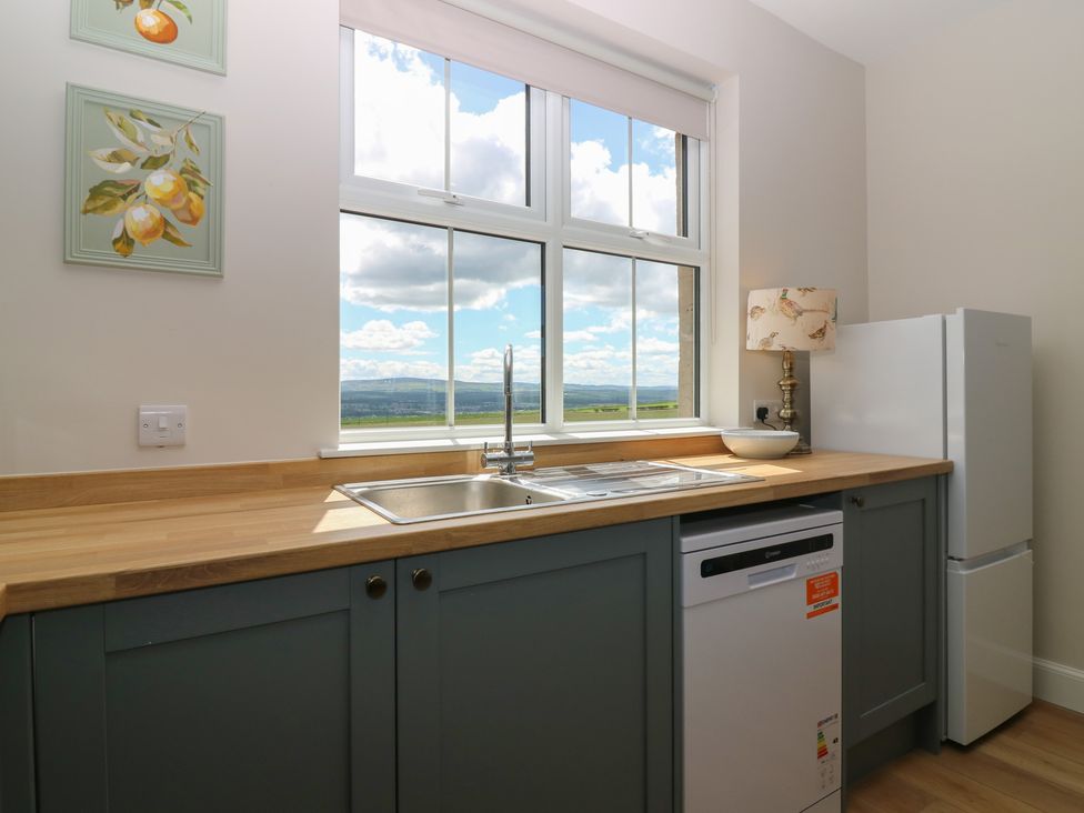 A kitchen with a sink, refrigerator and dishwasher at No 6 - 2 bed Haddington