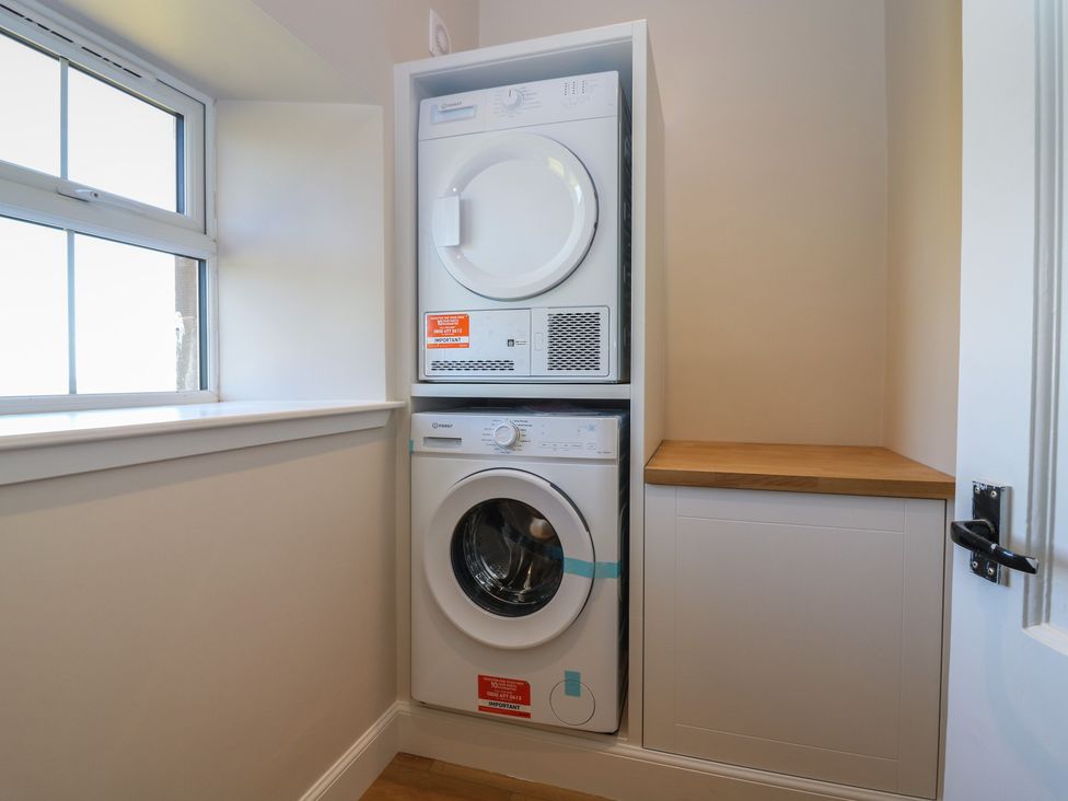 A utility room with a washing machine and tumble dryer at No 6 - 2 bed Haddington