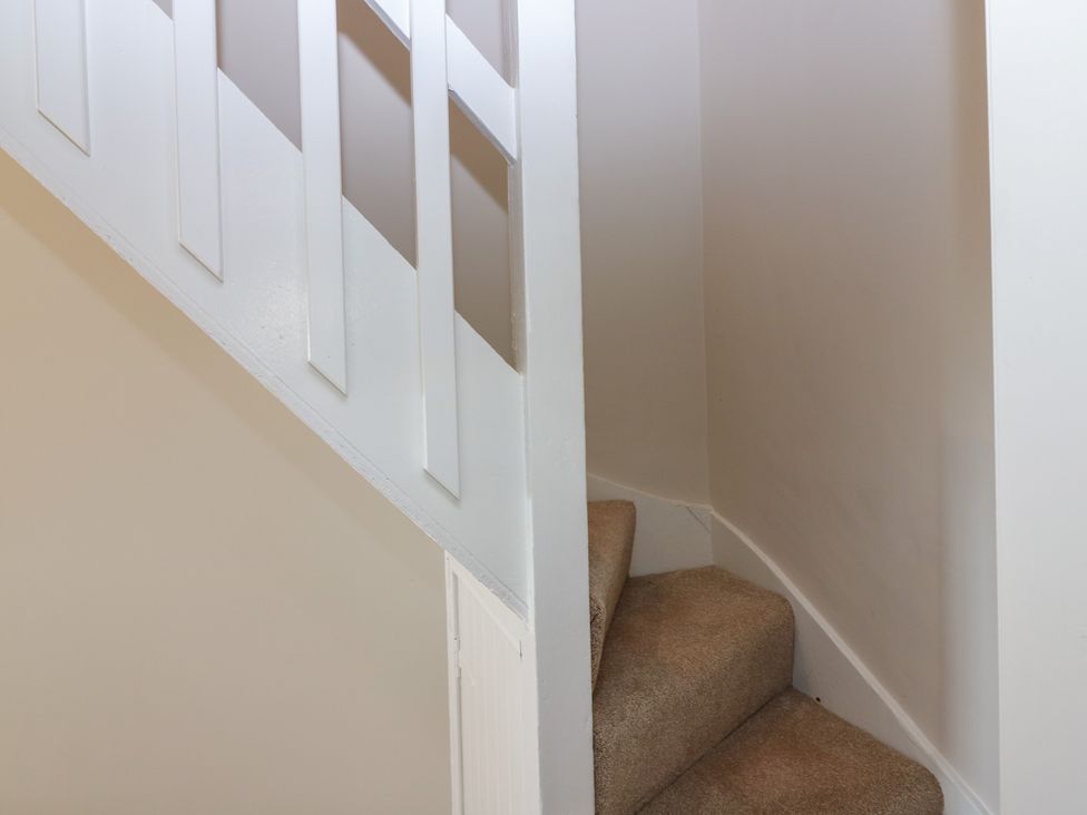 A staircase with carpet and wall rail at No 6 - 2 bed in Haddington