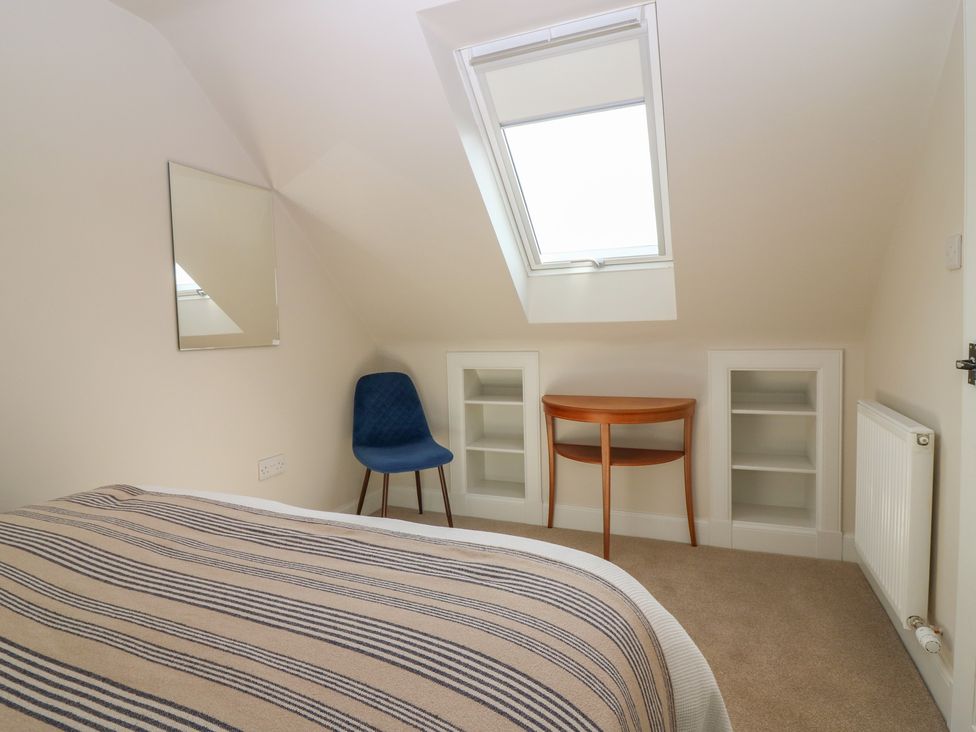 A bedroom with a bed and a table at No 6 - 2 bed Haddington