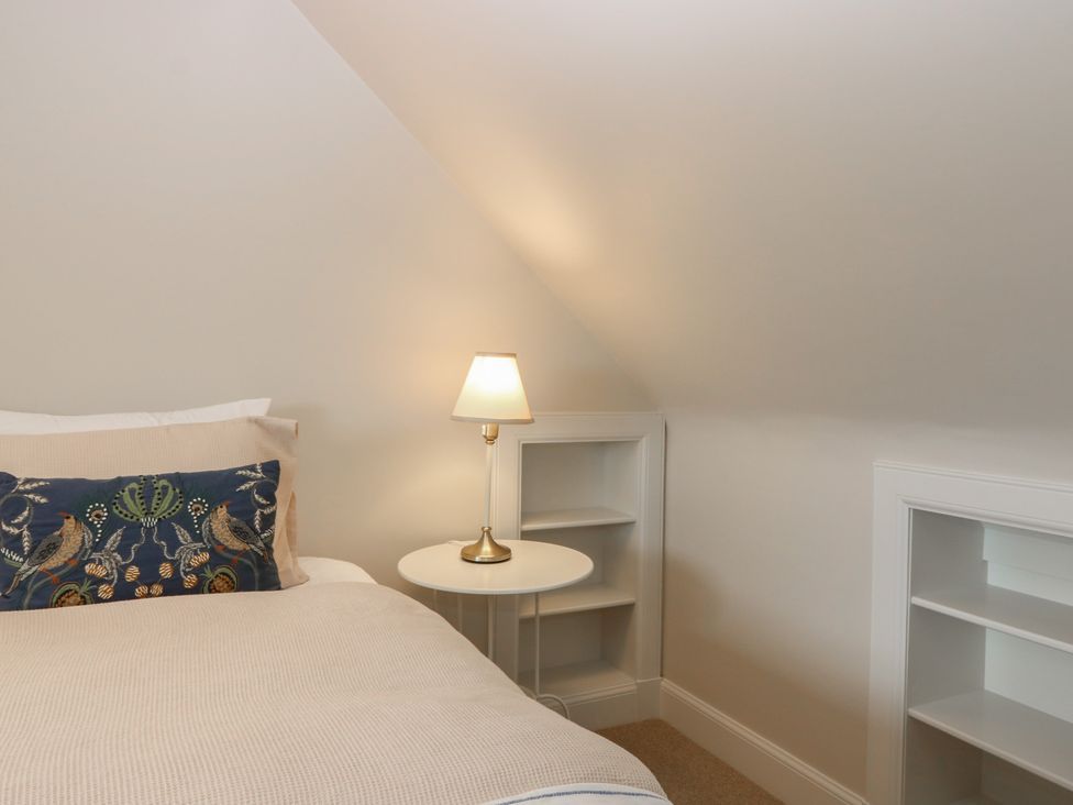 A bedroom with a bed and a bedside lamp at No 6 - 2 bed Haddington