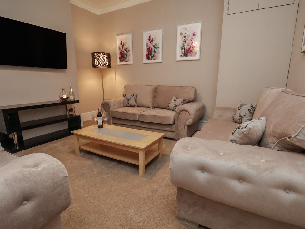 A living room with sofas and a coffee table at 11 Rutland Street in Filey