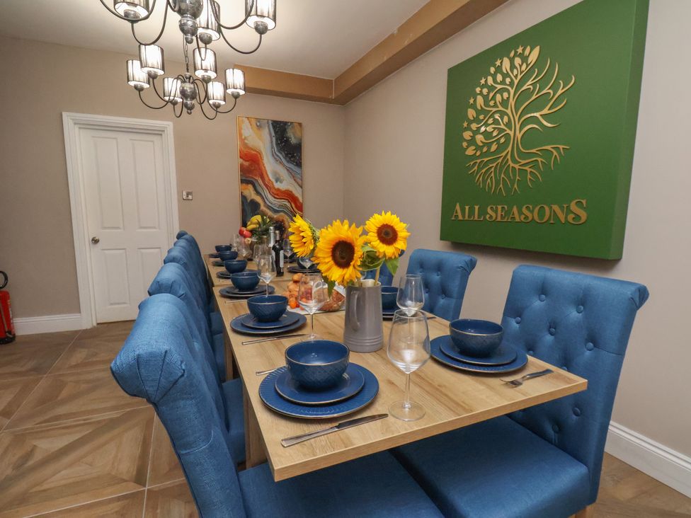 A dining room with a table set for guests at 11 Rutland Street Filey