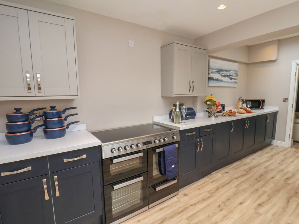 A kitchen with cabinets and appliances at 11 Rutland Street in Filey
