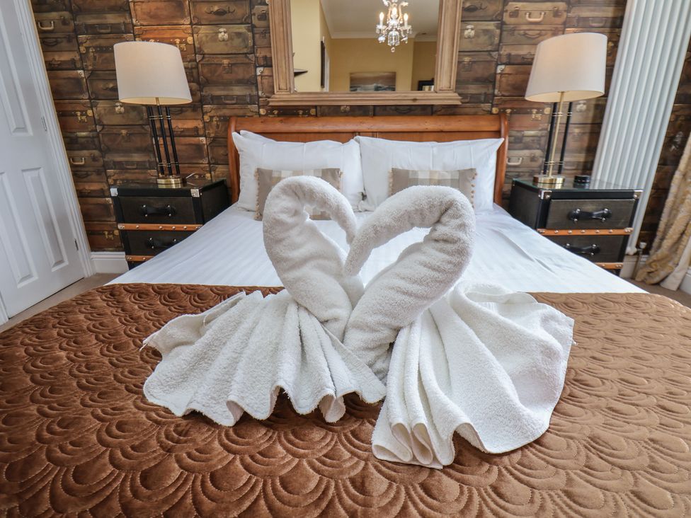 A bedroom with a towel sculpture on the bed at 11 Rutland Street in Filey