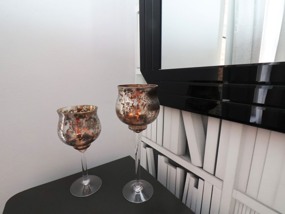 Two candlesticks on a table with a mirror in the background at 11 Rutland Street