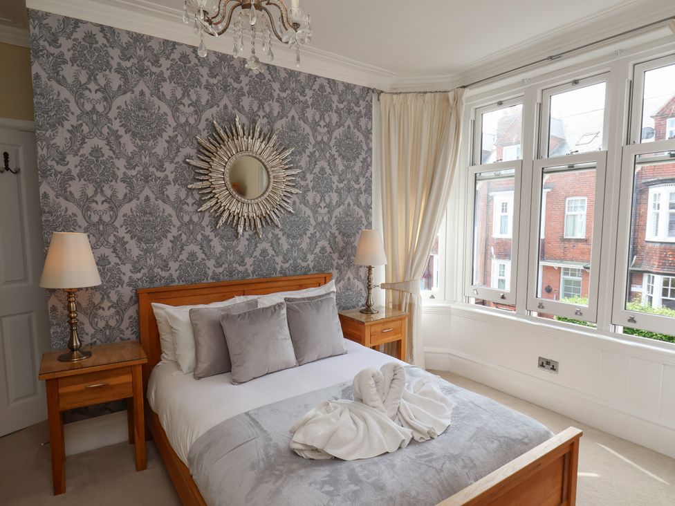 A bedroom with a bed and bedside table at 11 Rutland Street, Filey