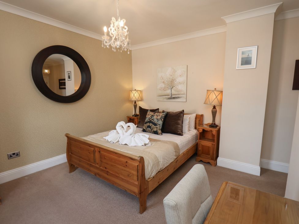 A bedroom with a bed and nightstand at 11 Rutland Street in Filey