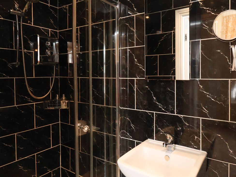 A bathroom with a shower and sink at 11 Rutland Street, Filey
