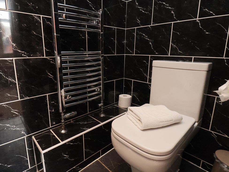 A bathroom with a toilet and towel rail at 11 Rutland Street in Filey