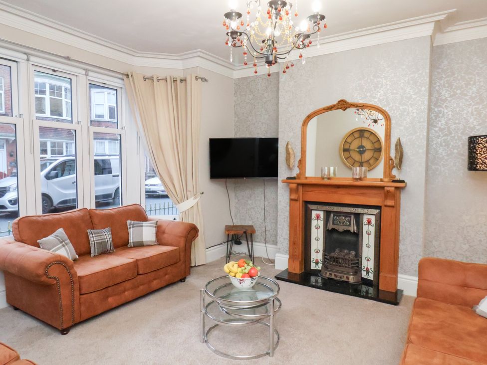 A living room with a fireplace and a television at All Seasons in Filey