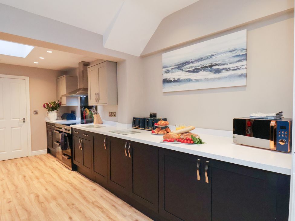 A kitchen with cabinets and a countertop at All Seasons in Filey