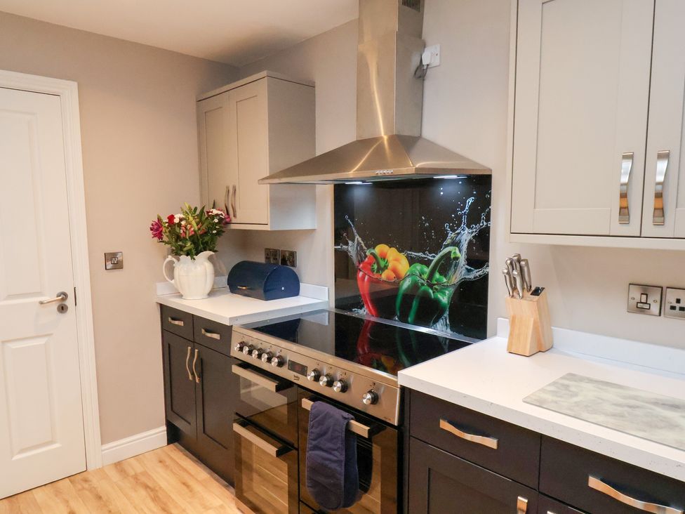 A kitchen with a stove and cabinets at All Seasons in Filey