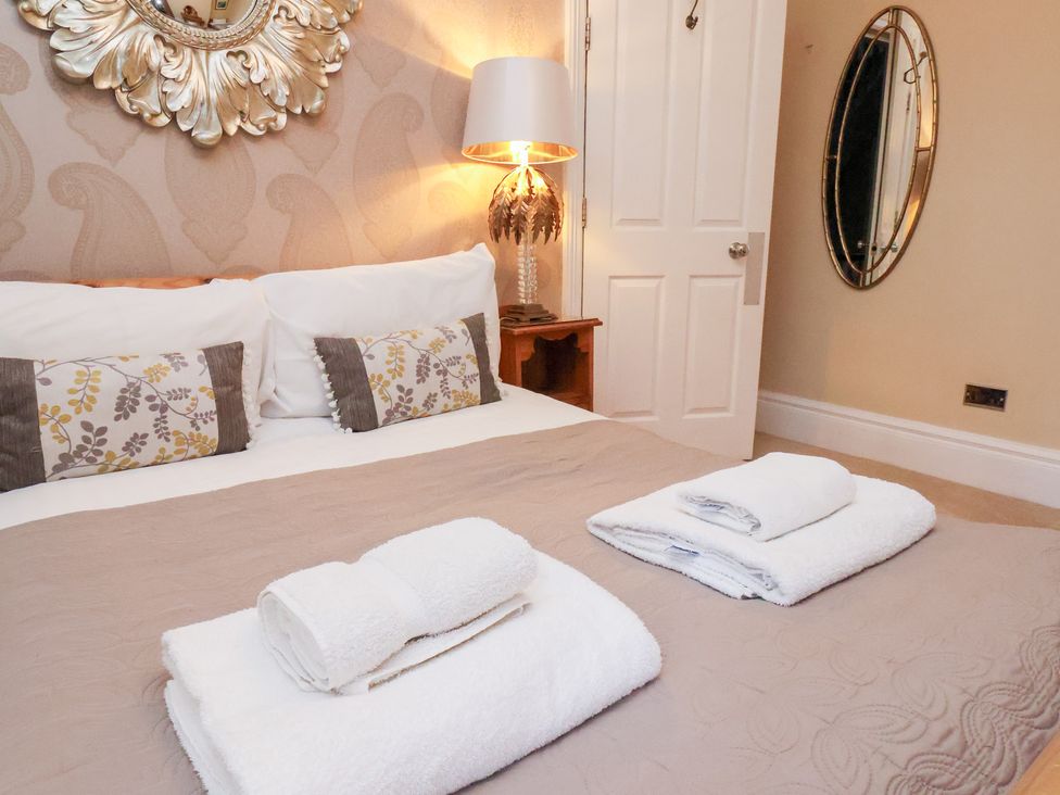 A bedroom with a bed and pillows at All Seasons in Filey