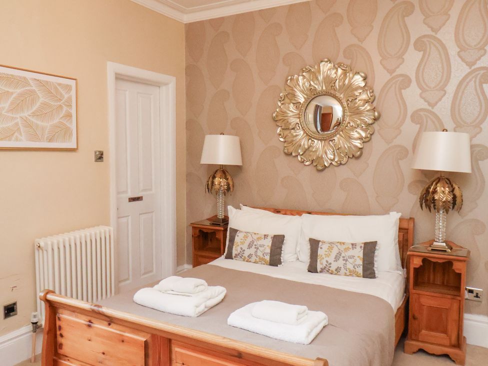 A bedroom with a bed and bedside tables at All Seasons in Filey