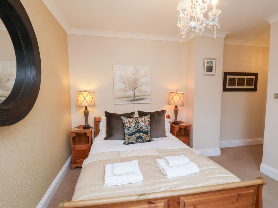 A bedroom with a bed and lamps at All Seasons in Filey