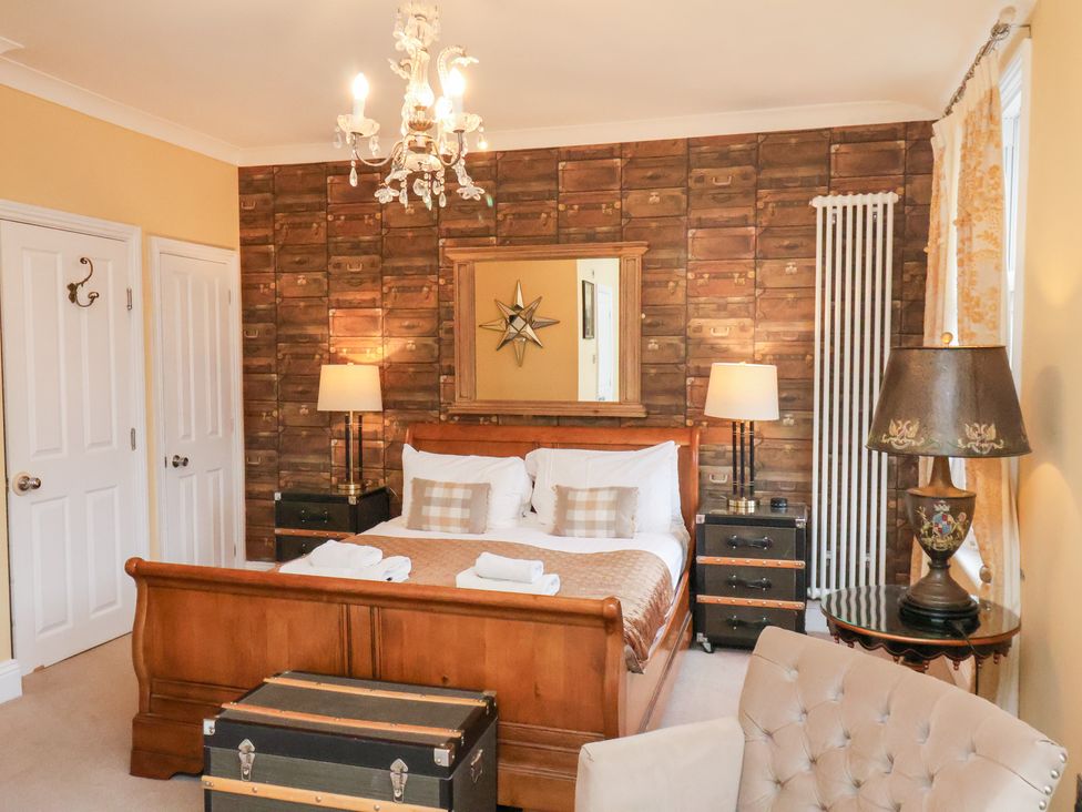 A bedroom with a bed and nightstands at All Seasons in Filey