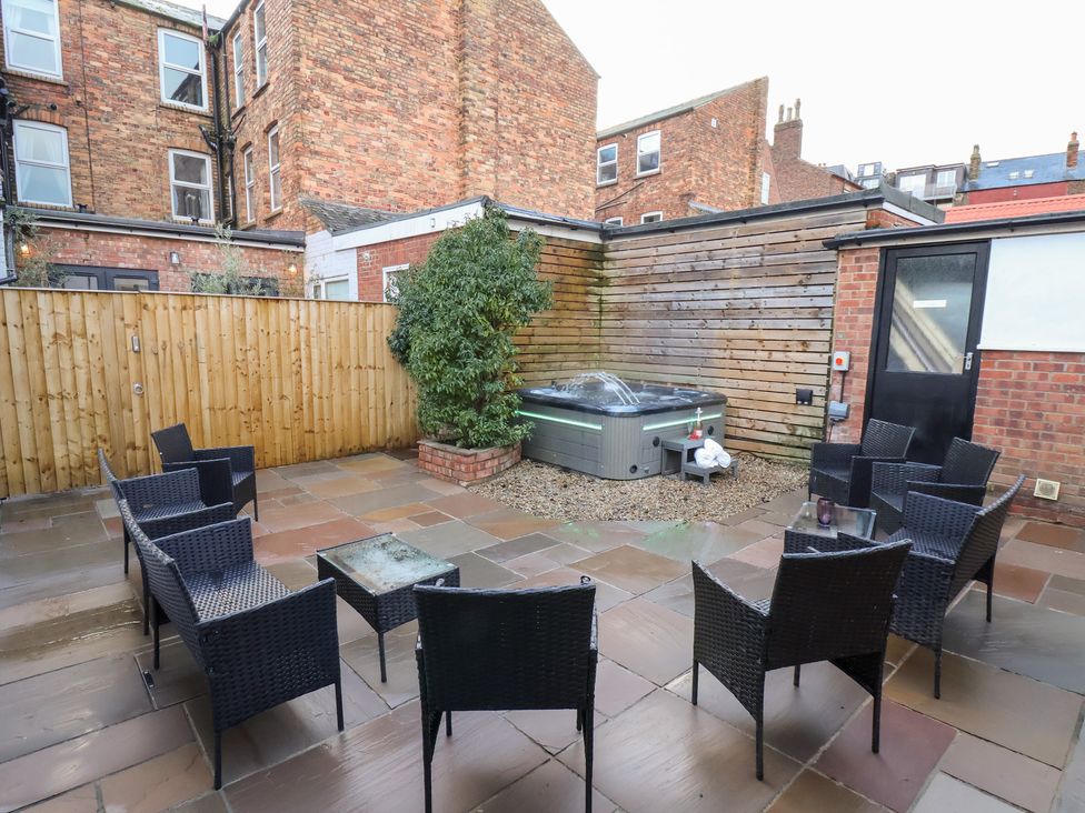 An outdoor area with seating and a hot tub at All Seasons in Filey