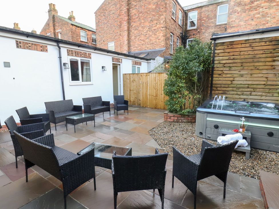 A garden area with outdoor seating and a hot tub at All Seasons in Filey