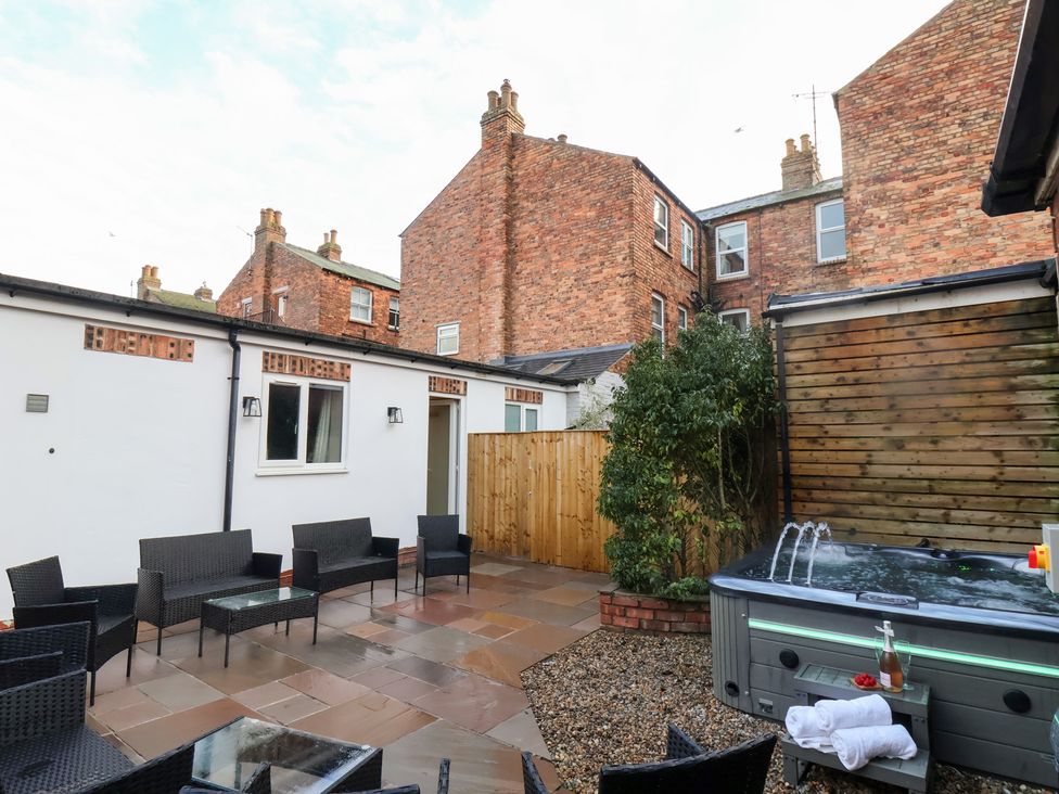 A garden with a seating area and hot tub at All Seasons in Filey