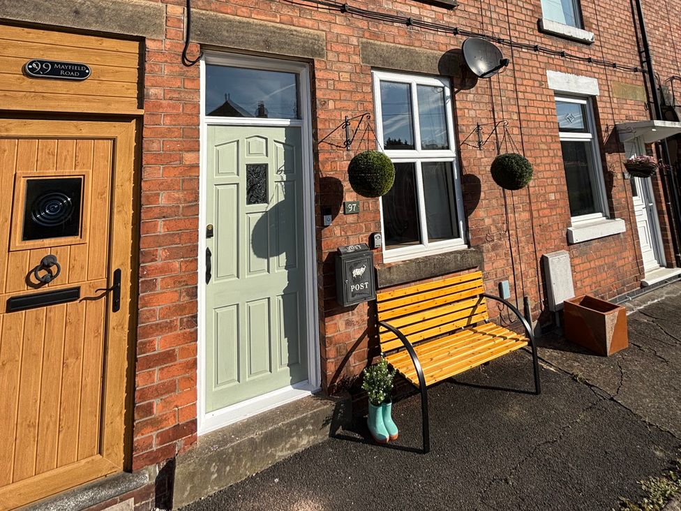 An outdoor area with a green door and a bench at 97 Mayfield Road, Ashbourne