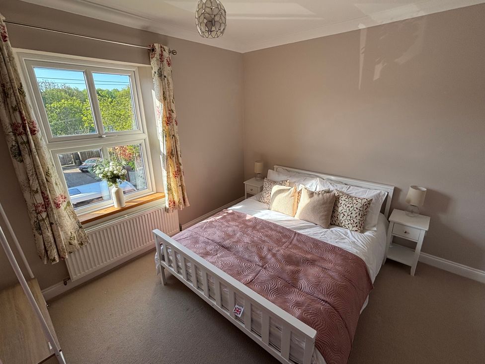 A bedroom with a bed and nightstands at 97 Mayfield Road in Ashbourne