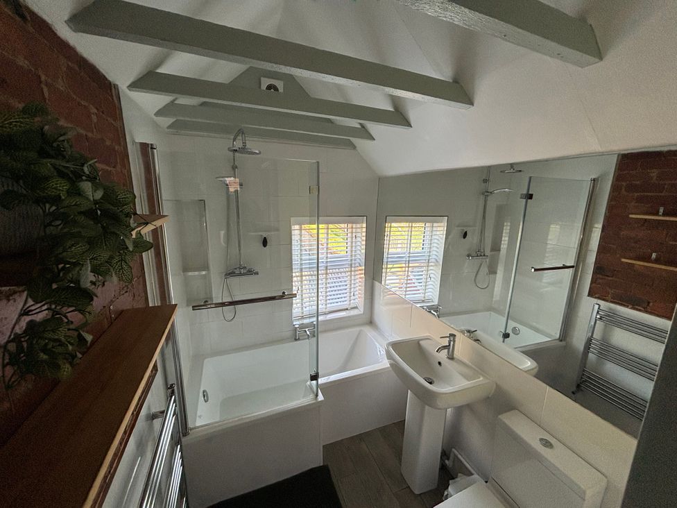 A bathroom with a bathtub, shower, sink, and toilet at 97 Mayfield Road in Ashbourne