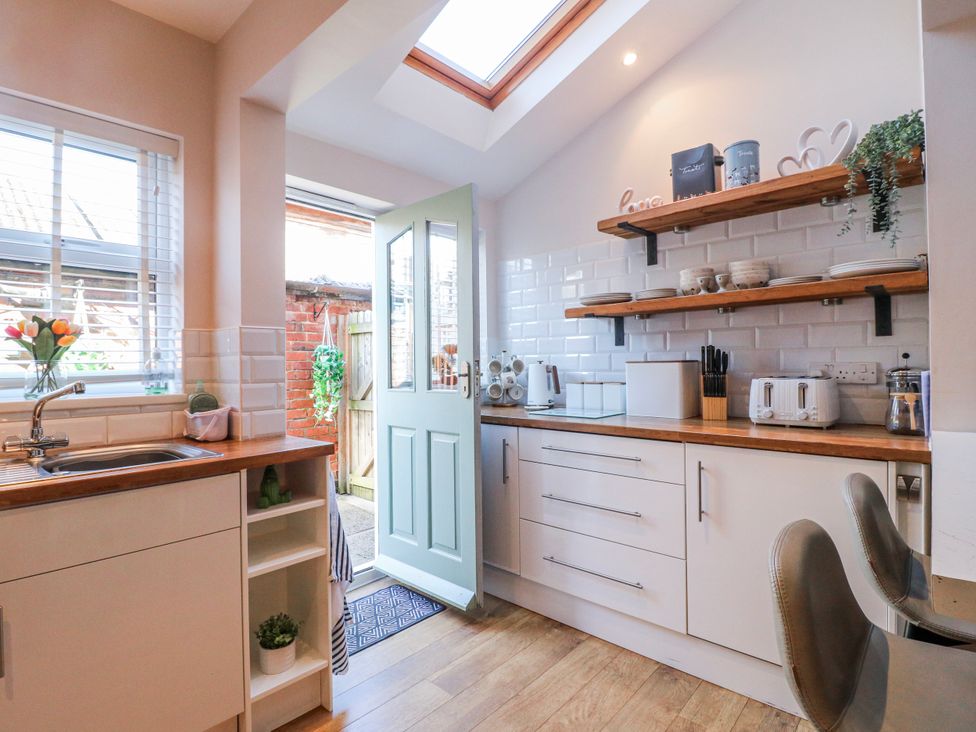 A kitchen with cabinets and appliances at Hill View Cottage in Ashbourne