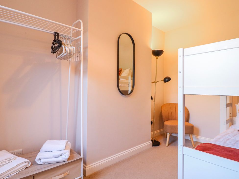 A bedroom with a bunk bed and a chair at Hill View Cottage Ashbourne