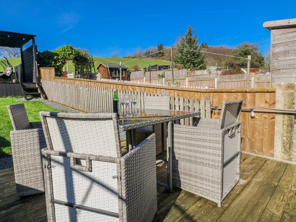 An outdoor seating area with a table and chairs at Hill View Cottage Ashbourne