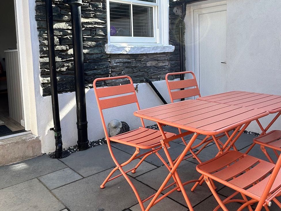A table and chairs on a patio at Capella Cottage in Keswick