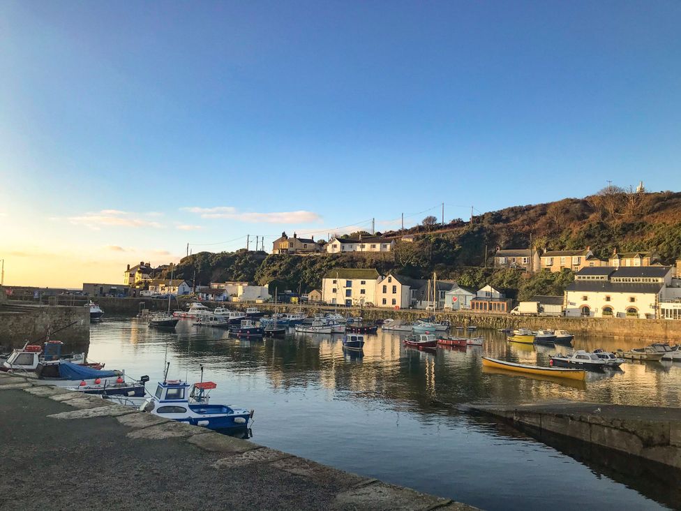 A harbor with boats and buildings in the background at The Loft in Porthleven