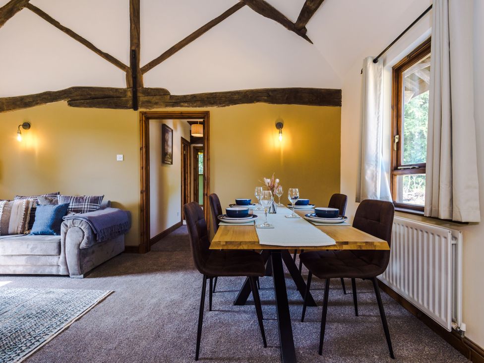 A dining room with a table set for a meal at Idris Barn Dolgellau