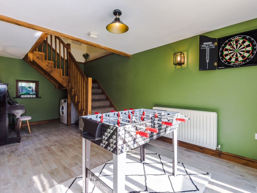 A snug with a foosball table and dartboard at Idris Barn Dolgellau
