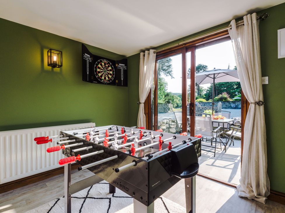 A game room with a foosball table and dartboard at Idris Barn Dolgellau