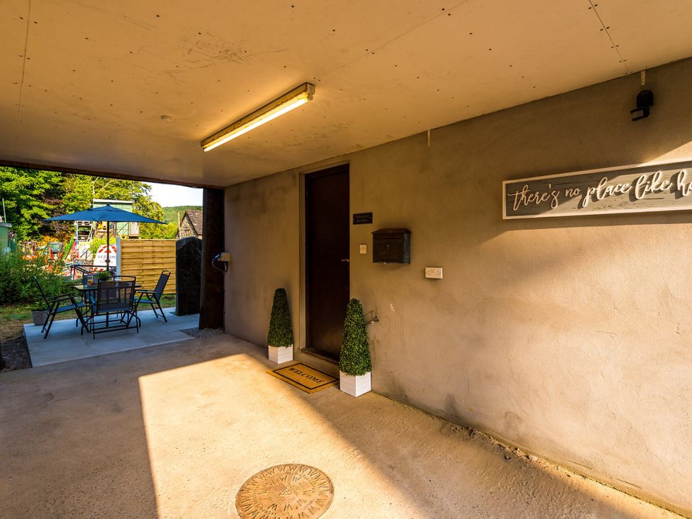 An outdoor entrance with a table and chairs at Idris Barn in Dolgellau