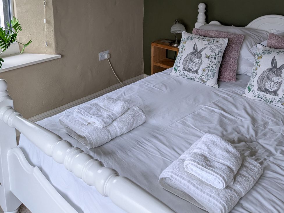 A bedroom with a bed and pillows at La Bastille in Maenclochog