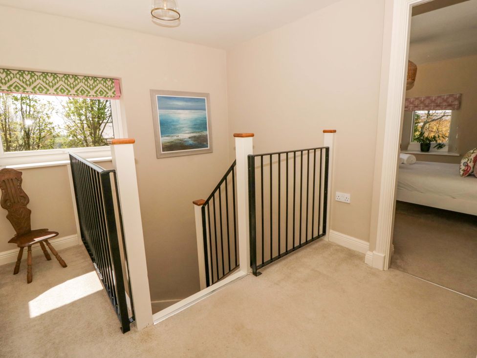 A landing with a staircase and window at La Bastille in Maenclochog