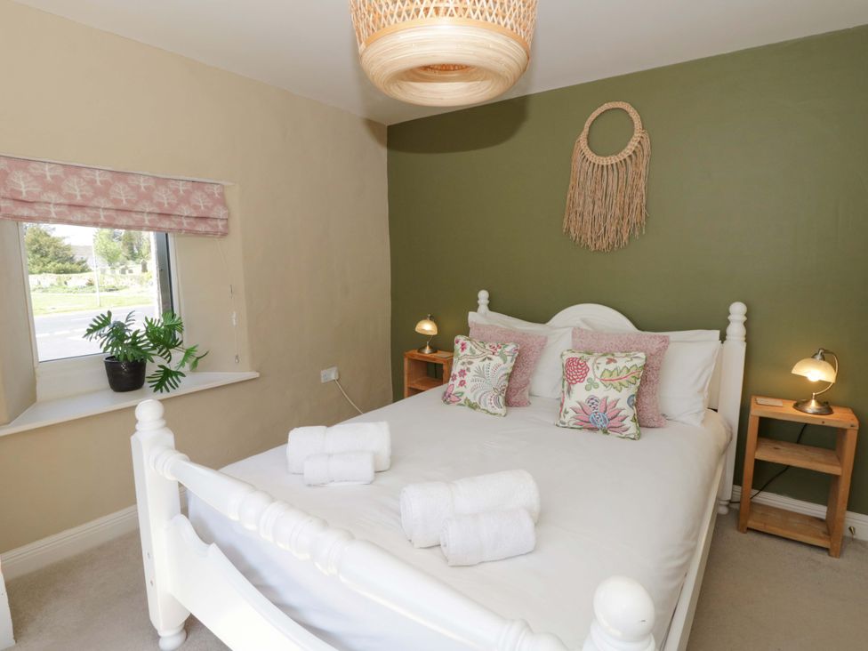 A bedroom with a bed and plants at La Bastille in Maenclochog